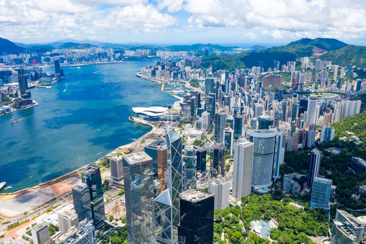 Image shows drone view of skyscrapers along Hong Kong waterfront taken by drone on daylight